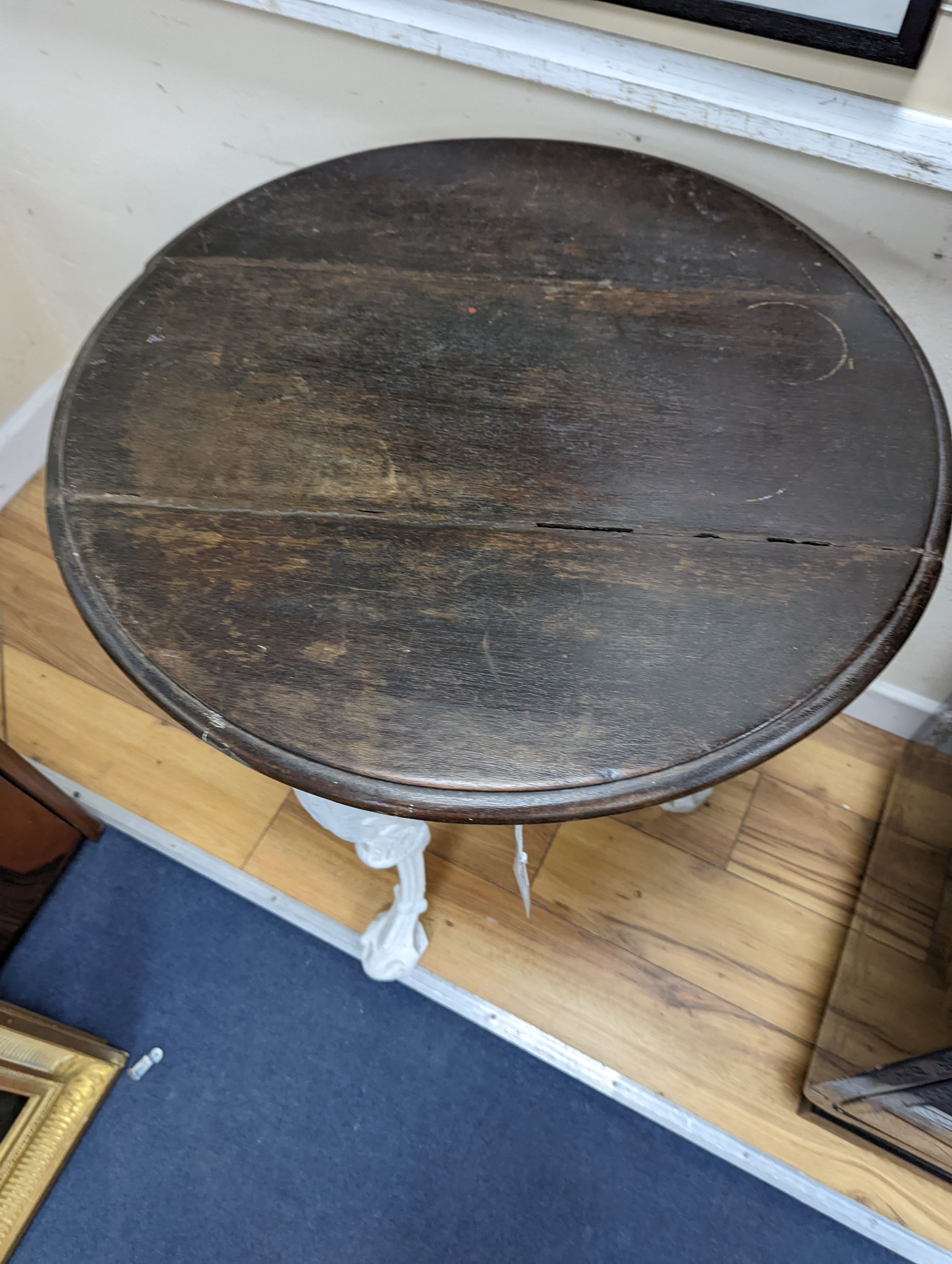 A Victorian white painted cast iron Britannia pub table, diameter 62cm, height 77cm